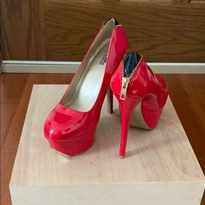 Red high heels with gold zipper